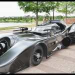 A batmobile is parked on the side of the road.