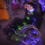 A man in a wheelchair at a party.