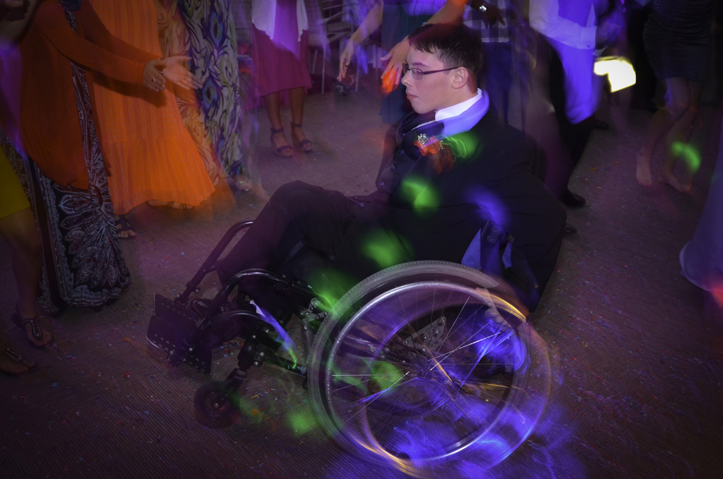 A man in a wheelchair at a party.