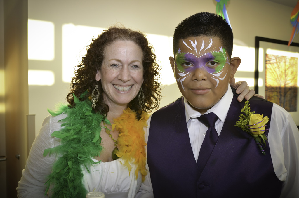 A woman and boy with face paint posing for the camera.