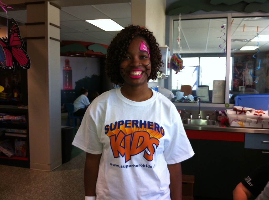 A girl with a face paint on her head.