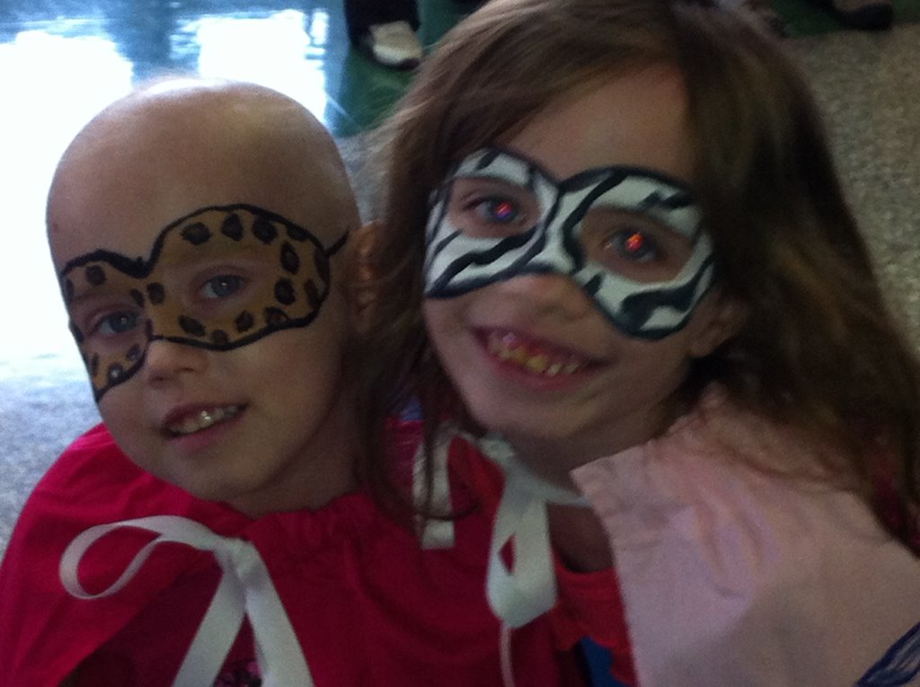 Two children with face paint on their faces.