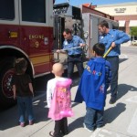 A group of people standing around a fire truck.