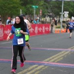 A woman running in the middle of a race.