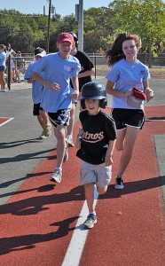 A group of people running on the pavement