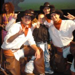A group of people in cowboy outfits posing for the camera.