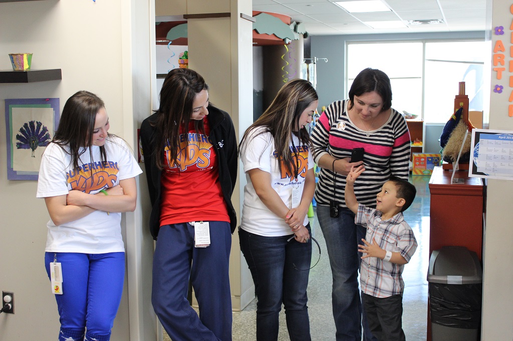 A group of people standing around each other.