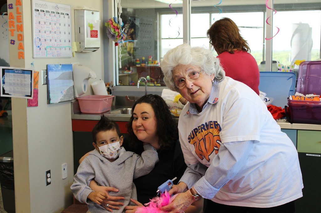 A woman and two children in a room.