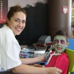 A woman and child with face paint on their faces.