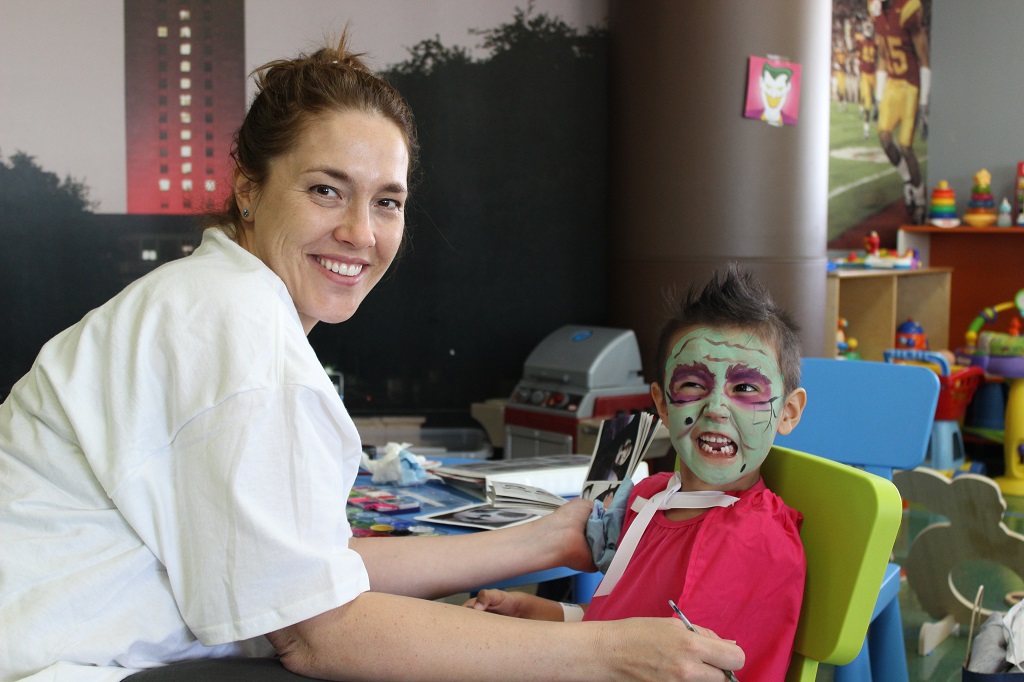 A woman and child with face paint on their faces.