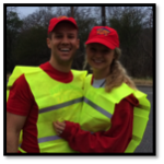 A man and woman wearing yellow vests and red hats.