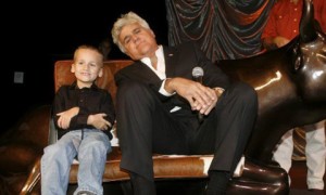 A man and boy sitting on top of a couch.